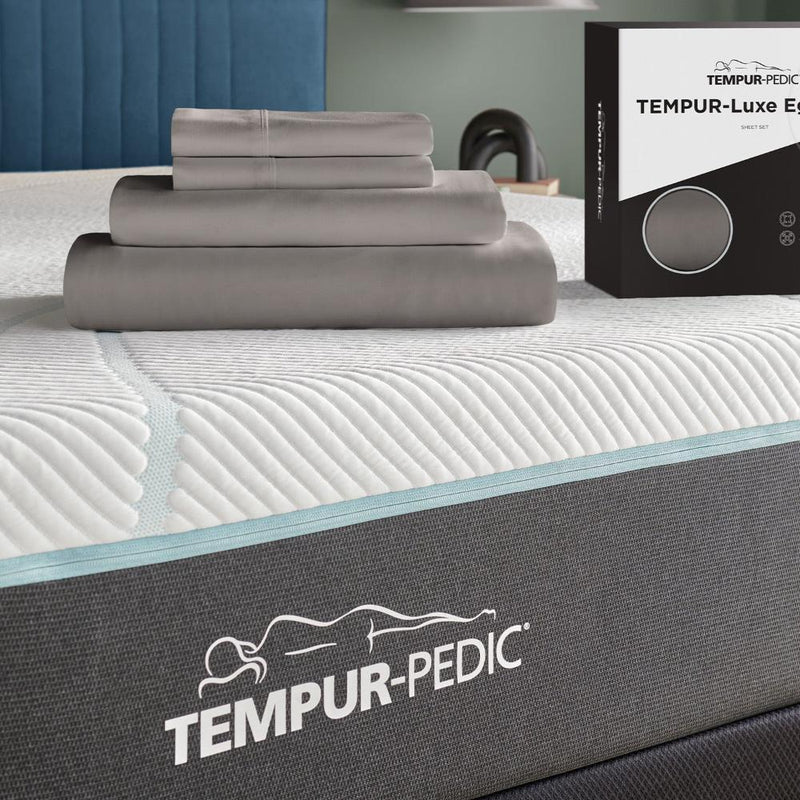 Tempur-Pedic Luxe Egyptian Cotton Sheets and packaging displayed on a mattress, highlighting the luxurious feel - Available at Sleepology Mattress Shop.