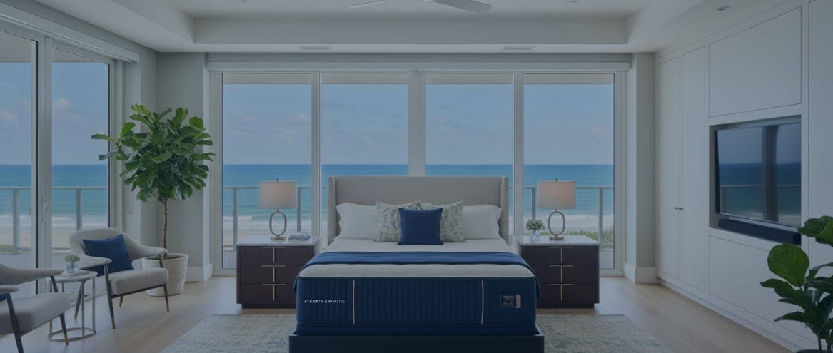 Modern bedroom with ocean view, bed, Stearns & Foster mattress from Sleepology, and furniture.
