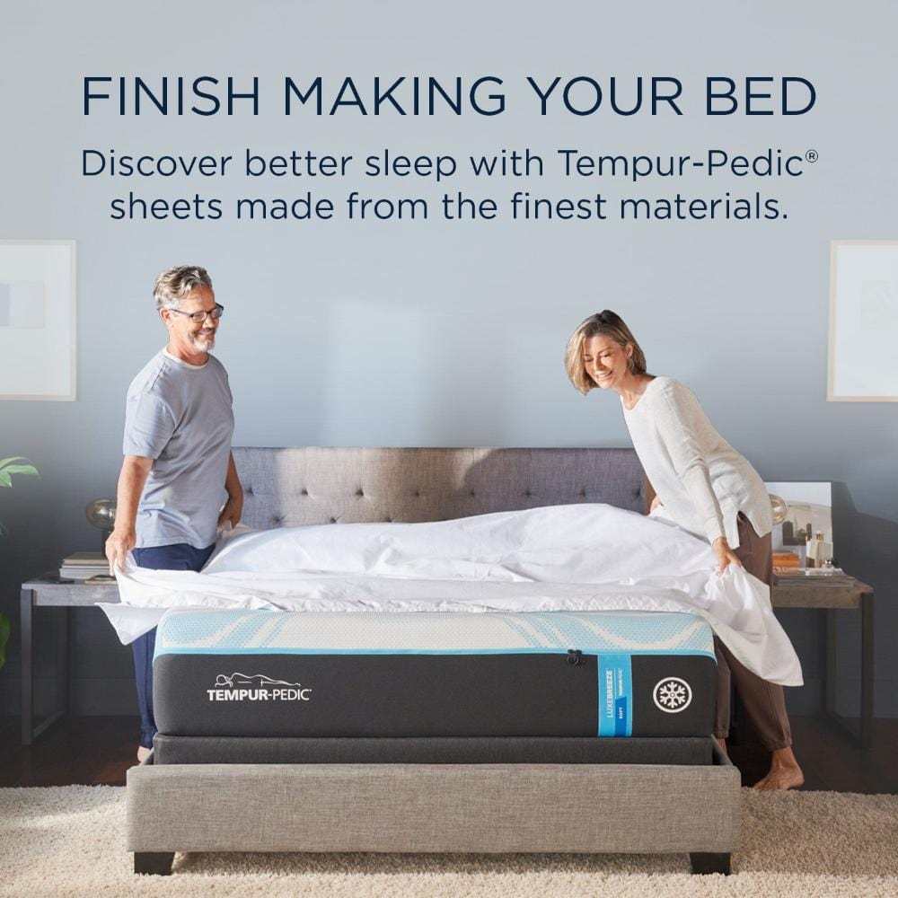 Couple making a bed with Tempur-Pedic Luxe Egyptian Sheets, showcasing the quality and comfort - Available at Sleepology Mattress Shop.